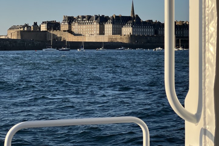 View of a coastal city with historic buildings from a boat.