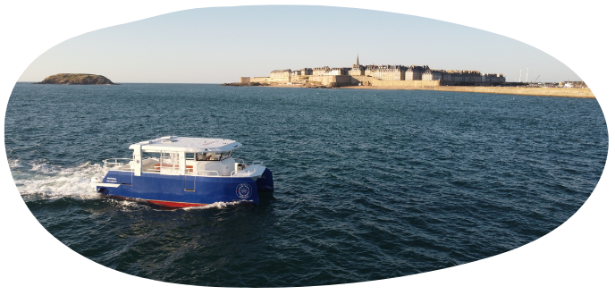 Blue boat on water with distant shore and buildings.